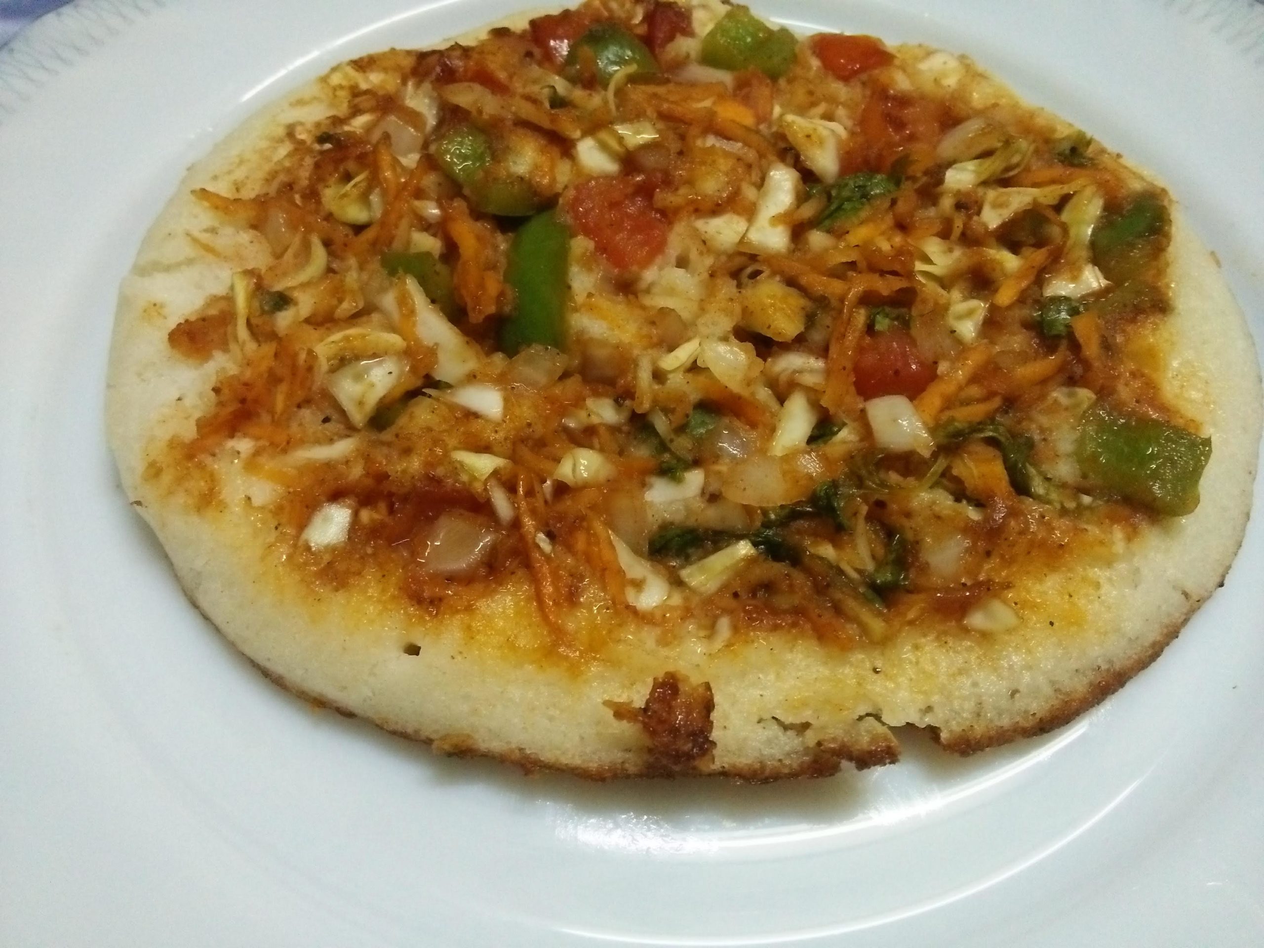 Veg Uttapam with onion and tomato toppings