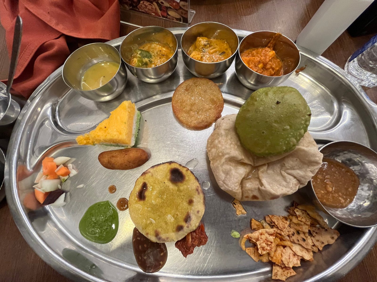 Thali Platter full of subzis, Puri, Farsan, Sweets, Dal and Rice with Buttermilk